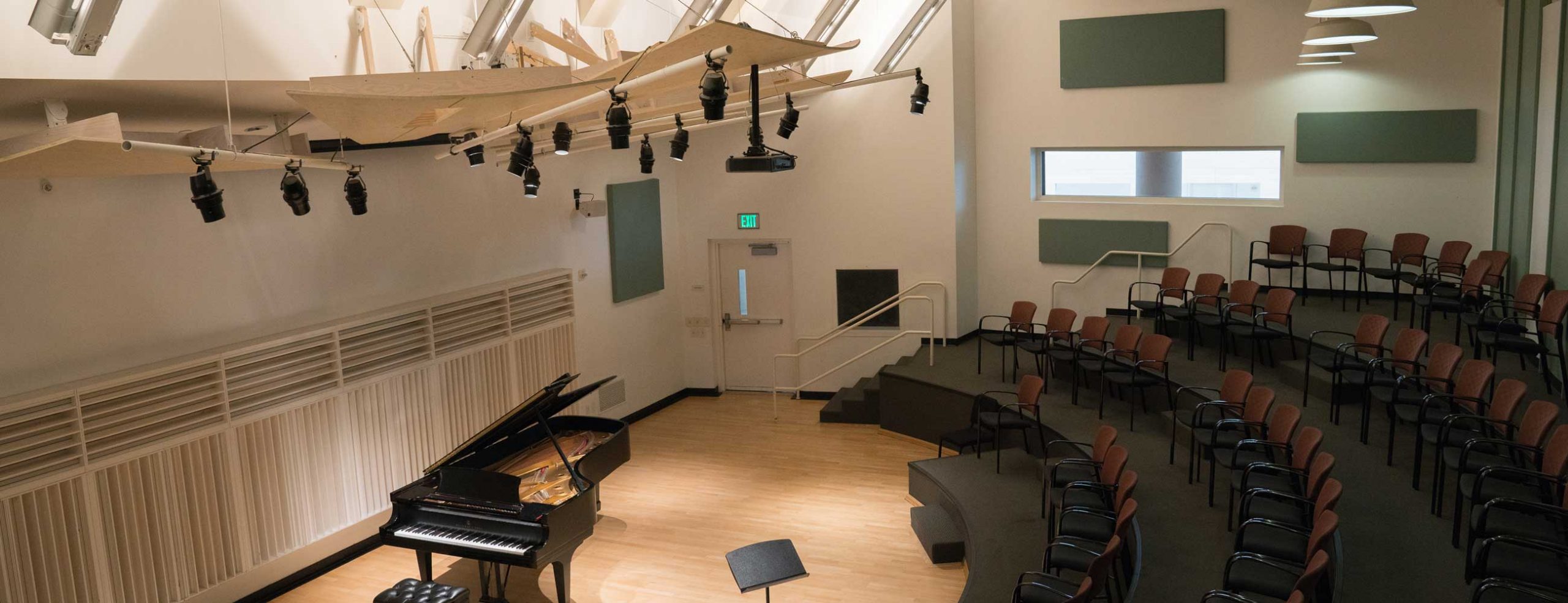 Overhead view of Mayman Hall with piano and empty lecture seats